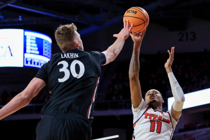 Dec 21, 2022; Cincinnati, Ohio, USA; Cincinnati Bearcats forward Viktor Lakhin (30) blocks the shot by Detroit Mercy Titans forward Gerald Liddell (11) in the second half at Fifth Third Arena. Mandatory Credit: Aaron Doster-USA TODAY Sports